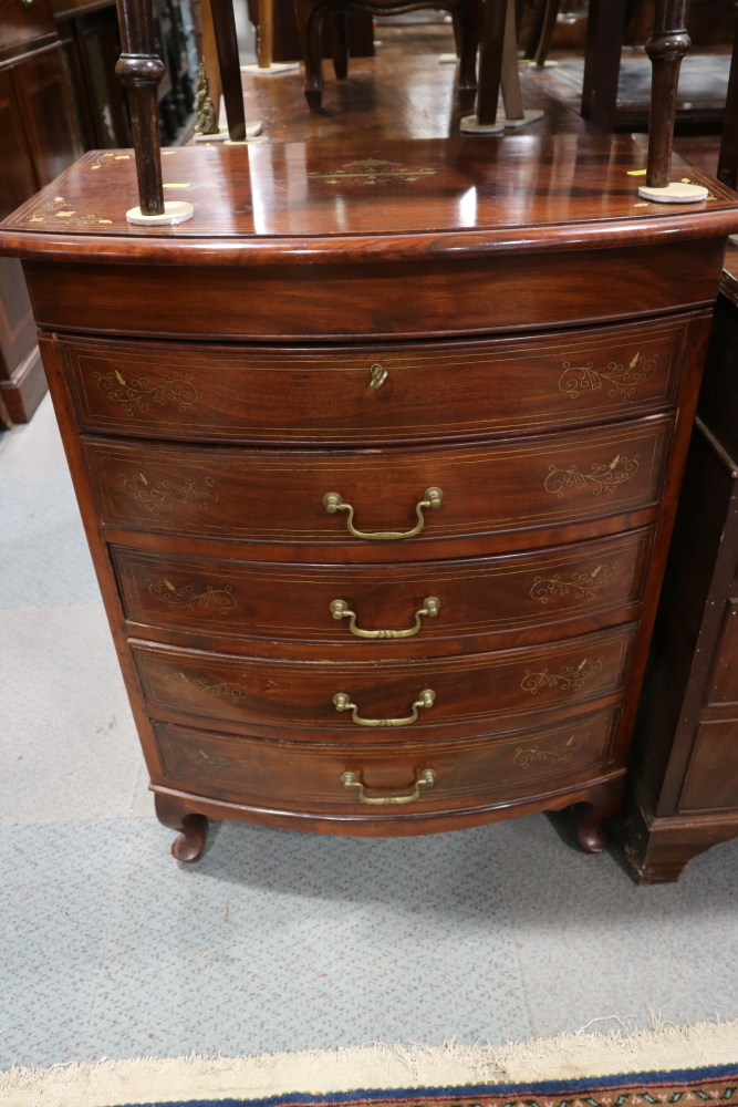 An Oriental hardwood and brass inlaid bowfront chest of four long drawers and lift up lid, on