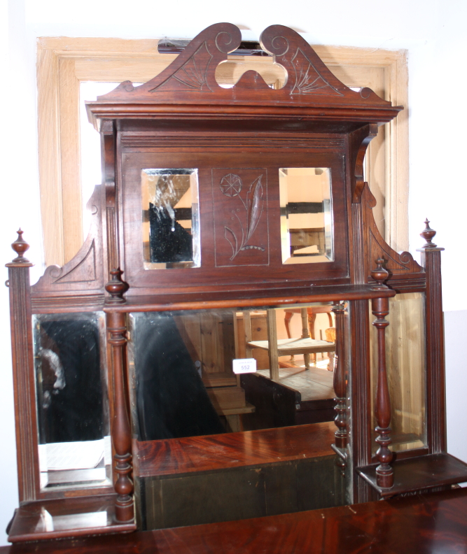 An Edwardian carved walnut overmantel, fitted five mirror plates and shelves, 36" wide