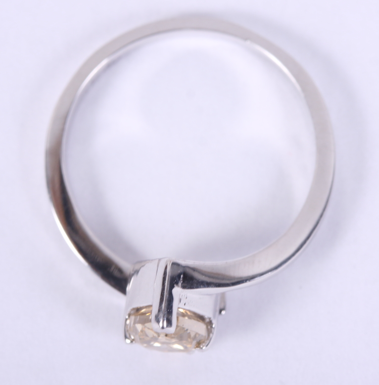 A pale brown pear-shaped solitaire diamond ring on cross-over shank, 0.9ct, size L 1/2, - Image 2 of 4