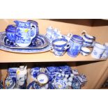 A quantity of Booths "Real Old Willow" pattern china, Ringtons storage jars, a cheese dish, platters