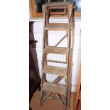 A stripped pine folding step ladder