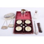A boxed set of four silver salts and spoons, a comb, a button hook, a christening mug, a brush, a