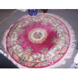 A Chinese circular rug with floral designs on a pink ground, 46" dia approx