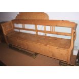 A stripped pine box seat bench, 87" long