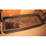 A cast iron rectangular trough with ring handles, 50" long