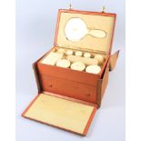 An ivory vanity set, in leather travelling two-compartment case, with fitted interior and canvas