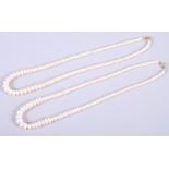 A string of graduated cultured pearls and another similar, 161/2" long