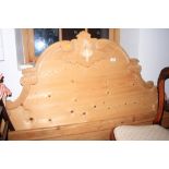 A stripped pine headboard with carved ornament, 54" wide