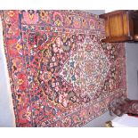 A Persian design rug decorated birds and flowers on a blue ground, 82" x 57" approx