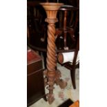 A Continental carved "Salomonic column" torchere stand, on scrolled base, 51" high