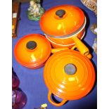 Four Le Creuset orange enamelled cast iron cooking pots, various