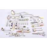 An assortment of silver plated cutlery, including a berry spoon, ladles, sugar tongs, servers, a