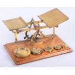 A brass set of weighing scales with pounds and ounces weights