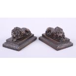 A pair of bronze recumbent lions, on plinth bases, 4 1/2" wide