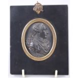 An 18th century Wedgwood & Bentley black basalt portrait medallion of Louis XVI, in ebonised and