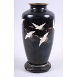 A 20th century Chinese cloisonne baluster vase, decorated cranes on a black ground, and associated