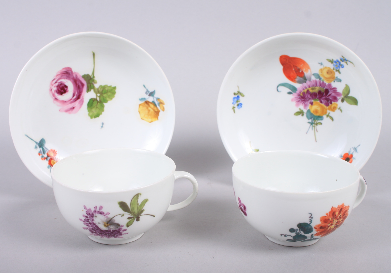 A pair of 19th century Meissen hand-decorated cups and saucers