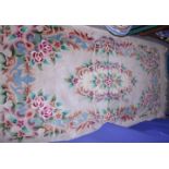 A Chinese wool contour pile rug with floral design in shades of natural, 75" x 36" approx