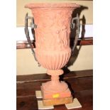 *A terracotta style urn, decorated in the classical manner, with metal handles, 16 " high, and