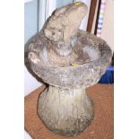 A cast stone birdbath and a stone model frog