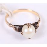 A yellow metal ring, set pearl with decorative shoulders, size O/P