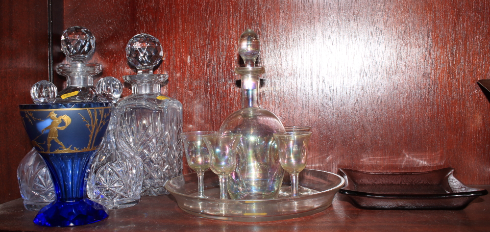 A lustre glass drinking set, two whisky decanters, a blue glass vase, decorated figures and dogs