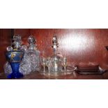 A lustre glass drinking set, two whisky decanters, a blue glass vase, decorated figures and dogs