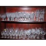 Seven etched brandy balloons, eight flutes, five air twist stem wines, and other glassware