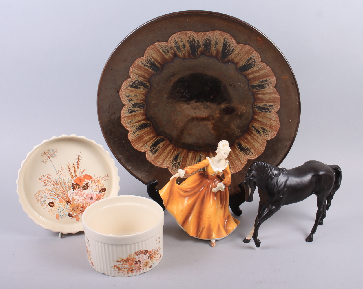 A Poole charger, designed by Jane Brewer, 15 1/2" wide, a Beswick model of a horse, a Royal