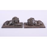 A pair of cast iron recumbent lions, on rectangular bases, 6" wide