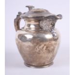 A 1920s silver hot water jug with inset Queen Anne coin to lid, a green man to spout and "C"