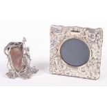 A silver mounted picture frame and a white metal Art Nouveau picture frame