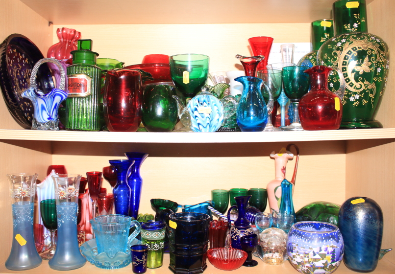 A quantity of coloured glass, including a pair of vases, drinking glasses, paperweights, a piece