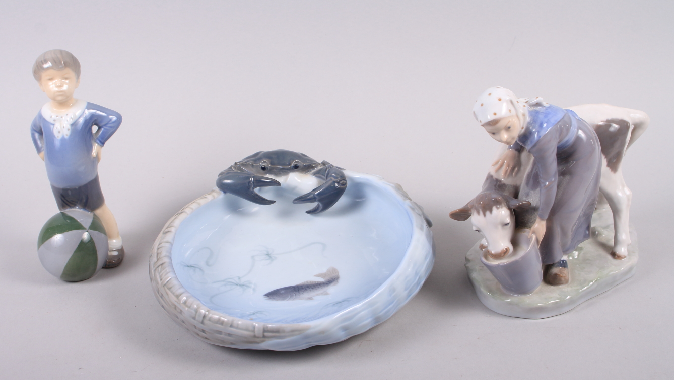 A Royal Copenhagen figure group, milkmaid and cow, 6" high, a dish decorated fish and relief crab,