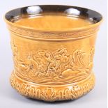 A Sylvac mustard glazed jardiniere, decorated in high relief with classical figures, 7" high