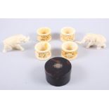 A set of four carved ivory napkin rings, two carved ivory model elephants and a tortoise shell