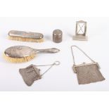 A silver travelling inkwell, a silver mesh purse, a similar smaller white metal purse, two silver