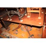 A 19th century mahogany rectangular tilt top tea table, on turned column and quadruple splay