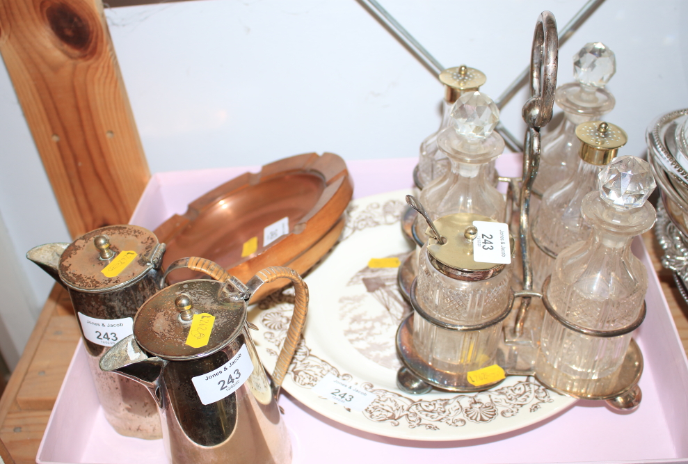 A silver plated cruet set, on stand, two hot chocolate pots, a copper and wooden ashtray, a Wedgwood