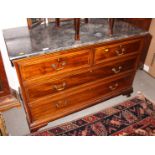 An early 19th century mahogany and satinwood banded chest of two short and two long drawers, on ogee