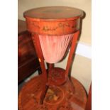 A Sheraton revival satinwood and painted circular top worktable, with fitted interior and