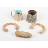 Two African bronze slave bangles, an Indian white metal mug, another similar, and an Eastern white