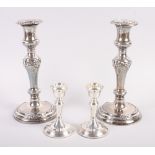 A pair of filled silver candlesticks, on circular weighted bases, 4 1/4" high, and a pair of
