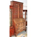 *A late Georgian mahogany bureau bookcase, the upper section enclosed Gothic lattice glazed doors,