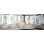 A pair of etched 19th century decanters, eleven other cut glass decanters and a glass vase