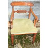 A William IV mahogany bar back elbow chair with stuffed over seat, on turned supports