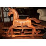 An Oriental hardwood rocking horse, 48" wide