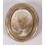 A Victorian mourning brooch with woven hair and yellow metal mounts