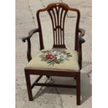 A Hepplewhite design carver chair with wheatsheaf back and drop-in needlepoint seat