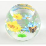 A Caithness limited edition, "Flutterbye" paperweight, decorated two flowers and a butterfly, 76/